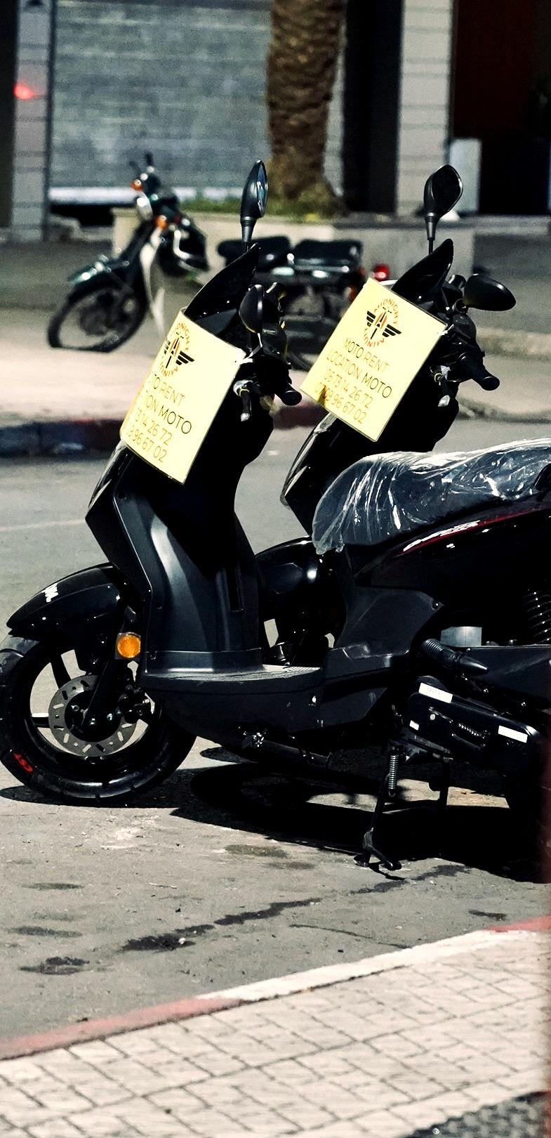 Scooters Minuit Midnight garés de nuit devant l'agence à Marrakech